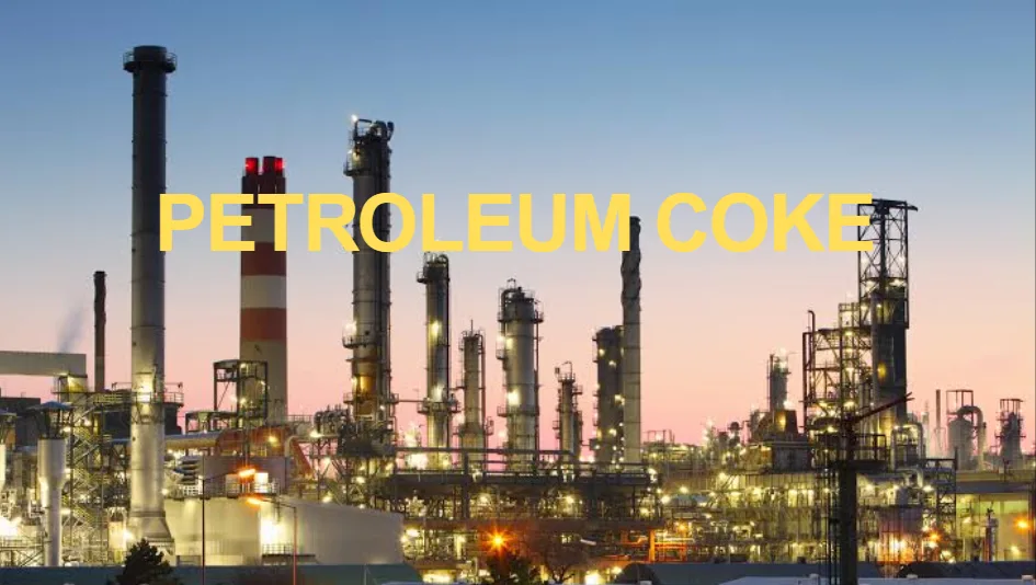 Refinery towers at dusk — petroleum coke production